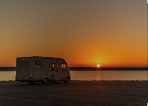 Campervan on the beach with a beautiful sunset