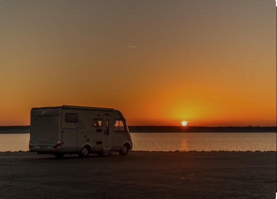 Campervan on the beach with a beautiful sunset